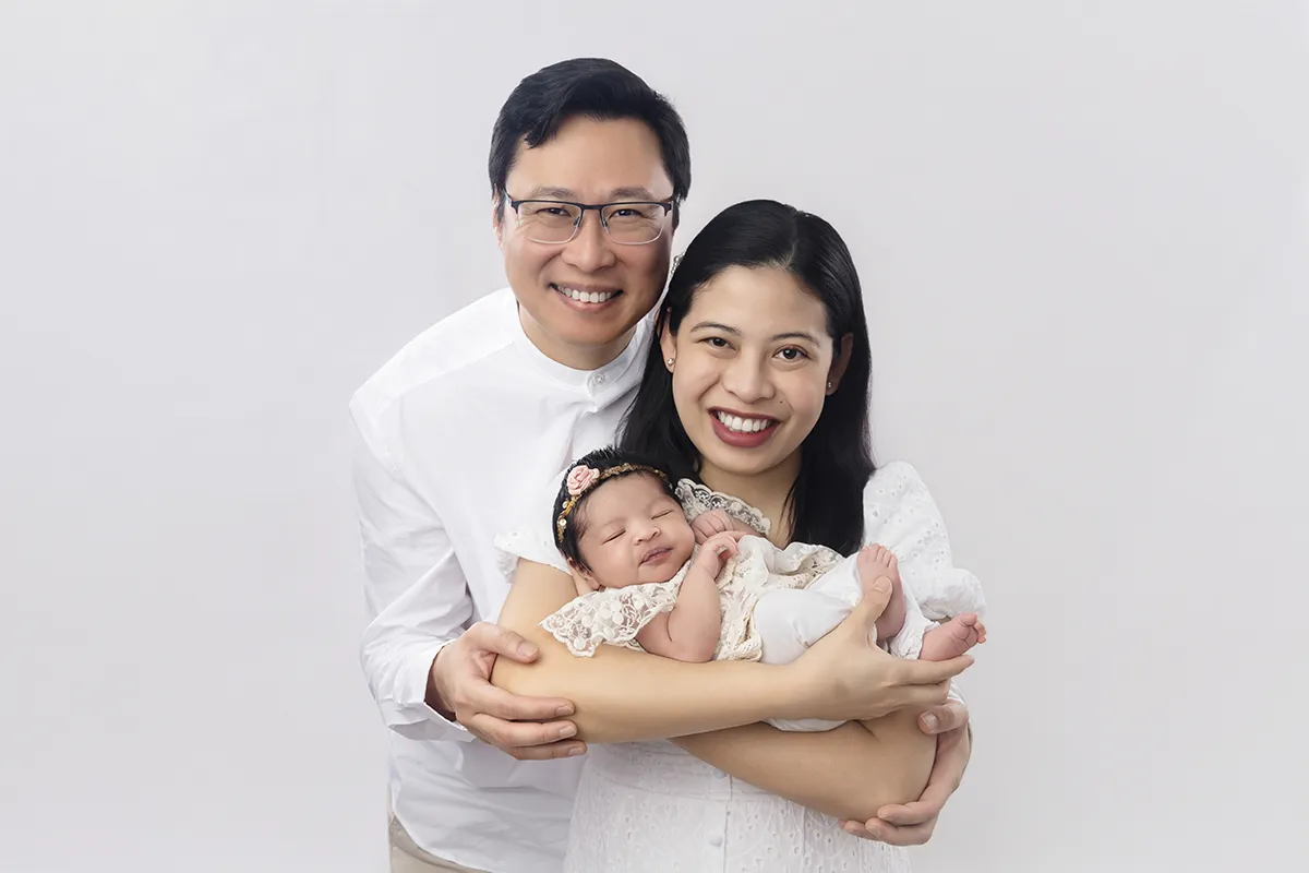 Parents holding their newborn baby during a family newborn photography session at Photo Hive