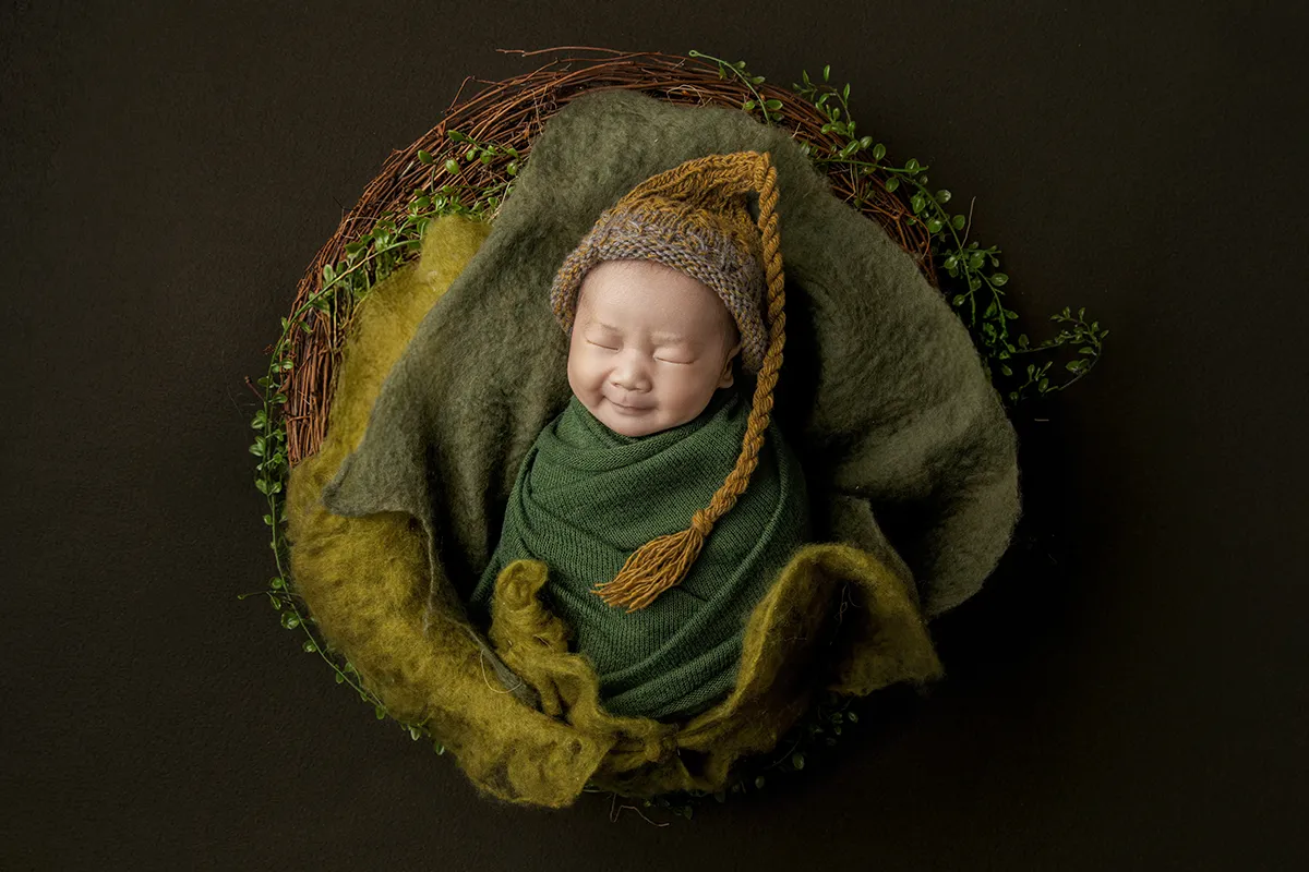 Newborn baby sleeping during a newborn photography session at Photo Hive Auckland studio